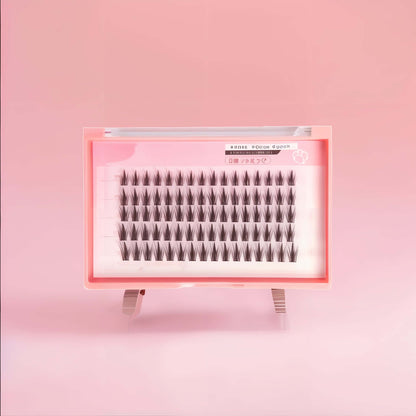 DIY Wispy Manga Cluster Lashes in pink tray for customizable, lightweight eye enhancement and anime aesthetics.