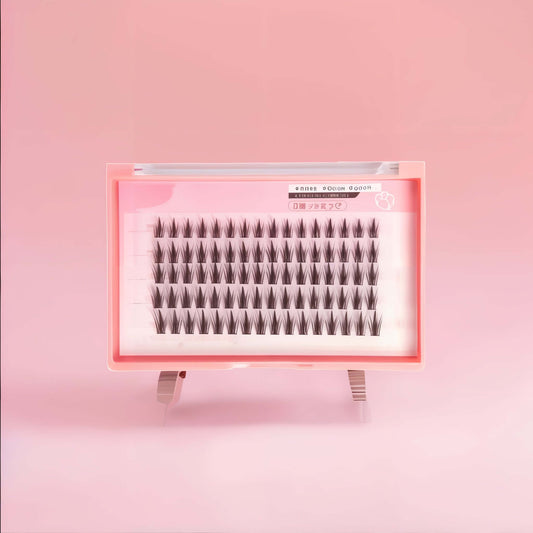 DIY Wispy Manga Cluster Lashes in pink tray for customizable, lightweight eye enhancement and anime aesthetics.